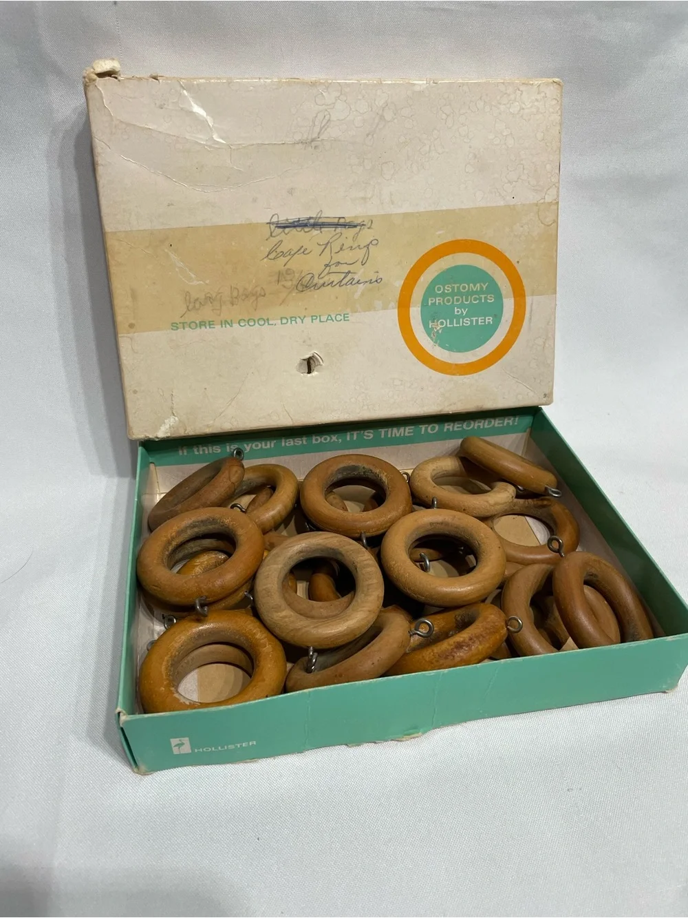 Set of 24 vintage wooden curtain rings feature metal screw eyes for drapery